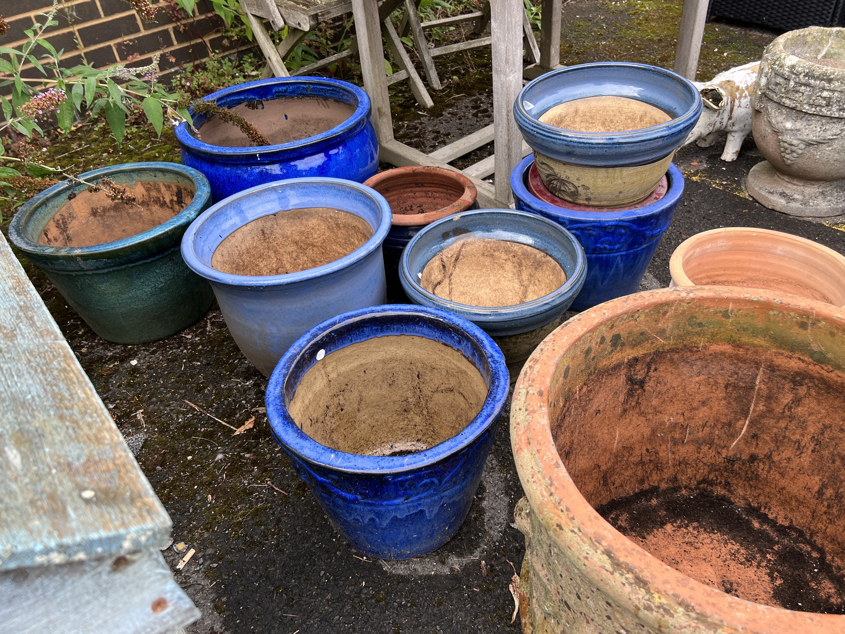 Twelve assorted earthenware garden planters, largest diameter 50cm, height 32cm